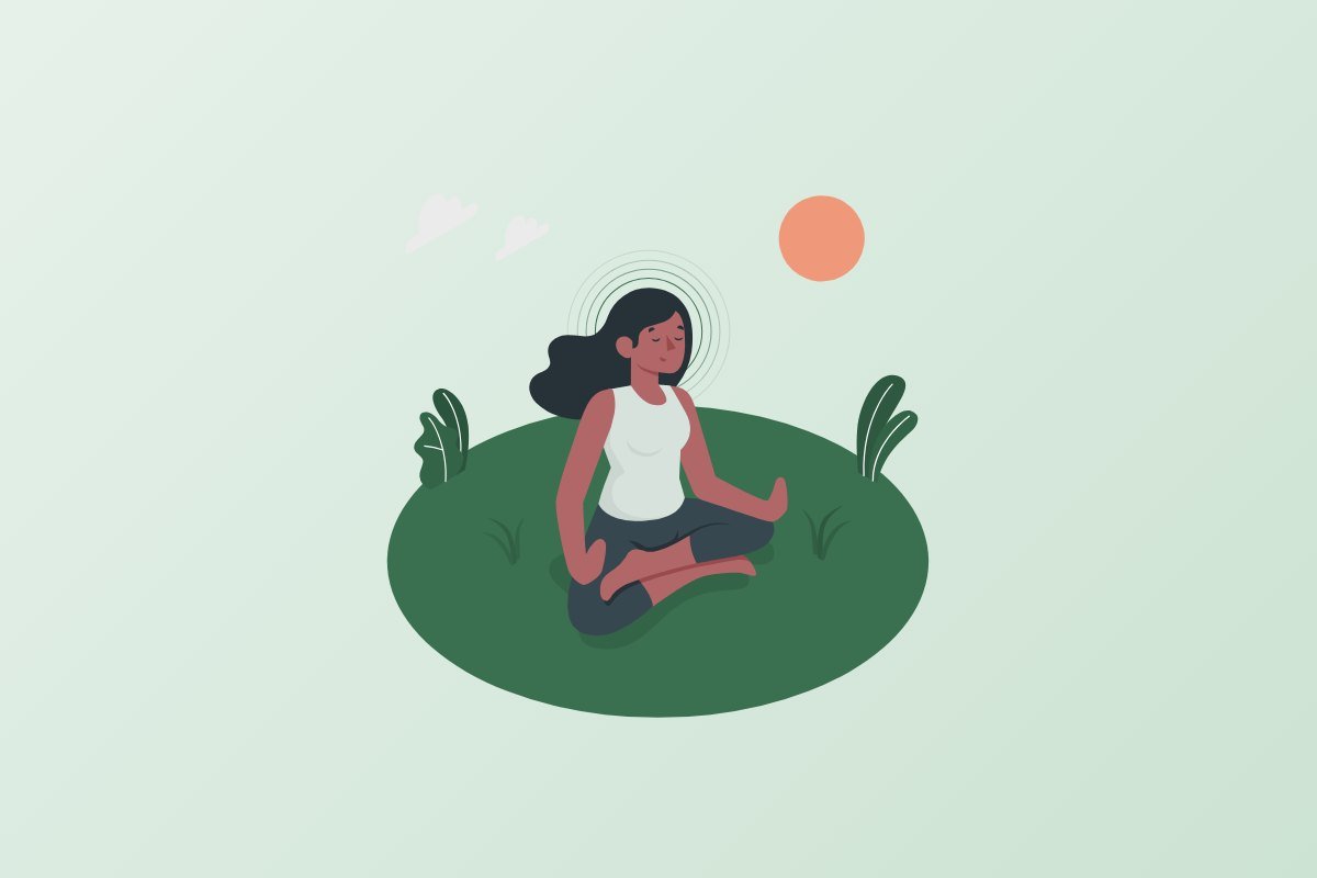Woman sitting in a calm, peaceful setting practising mindfulness